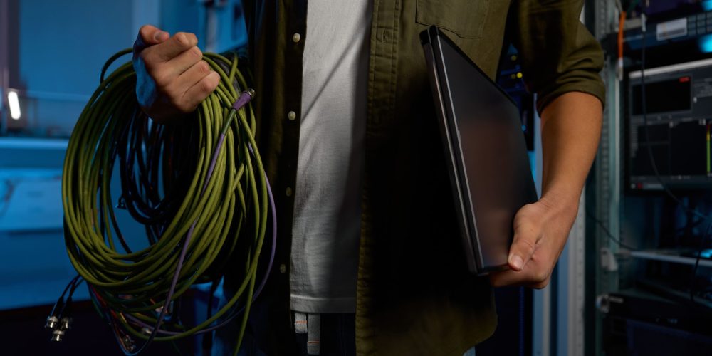 male-it-technician-holding-laptop-and-cables-2024-12-02-09-15-31-utc (1)